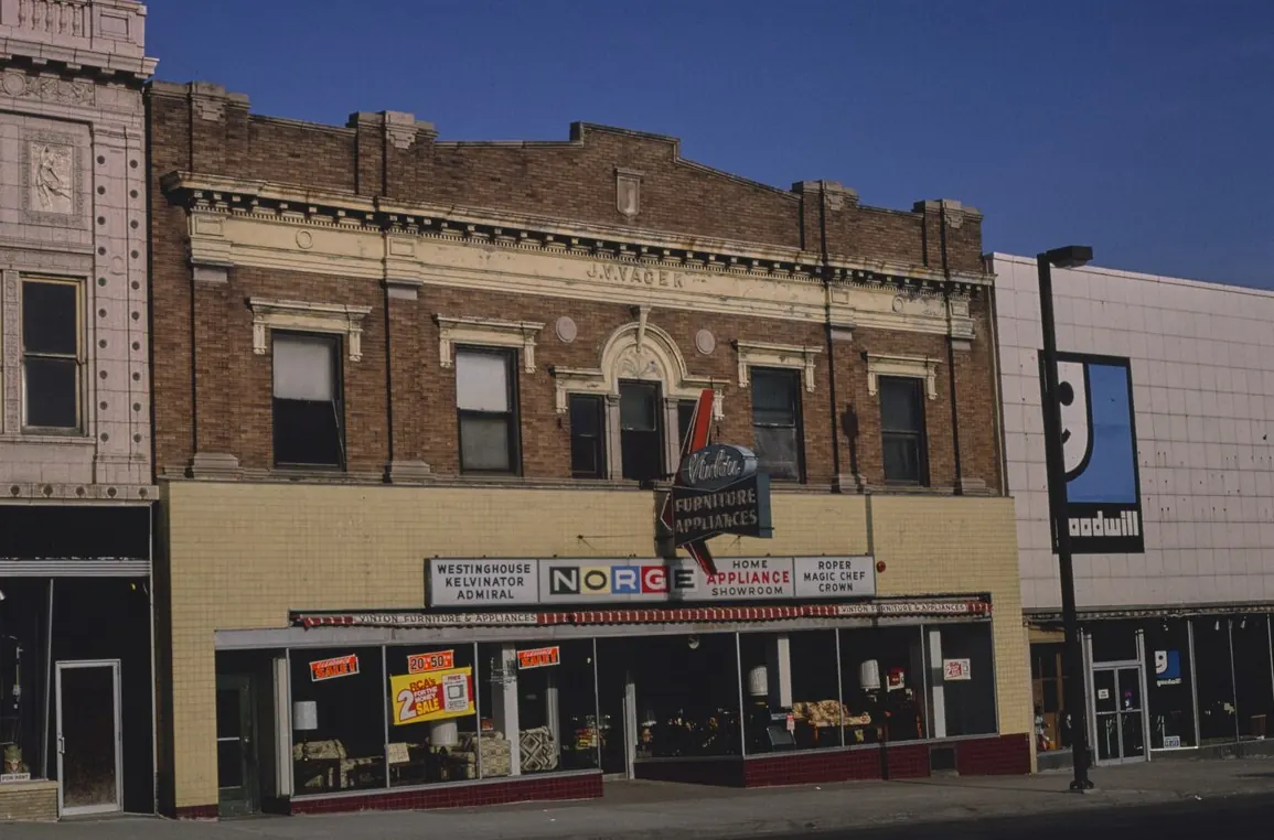 A brick commercial block with several shop fronts