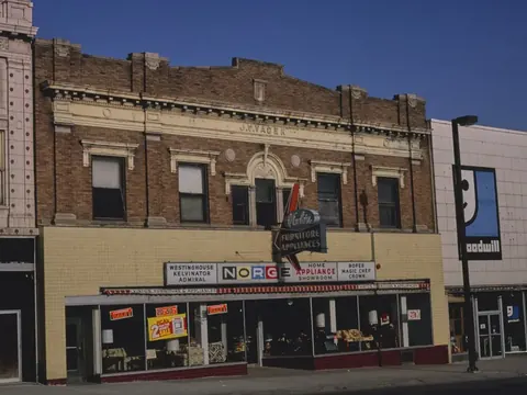 A brick commercial block with several shop fronts