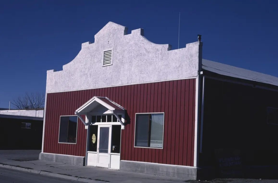 A red plumbing and heating shop with a white stepped front