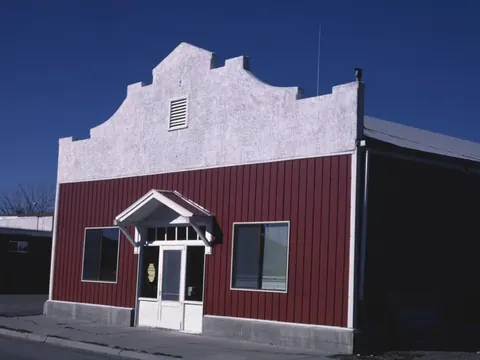 A red plumbing and heating shop with a white stepped front